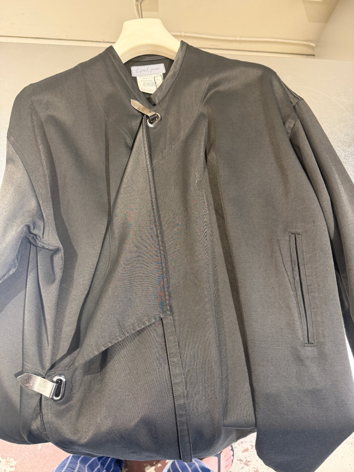 Black trench with metal buckling