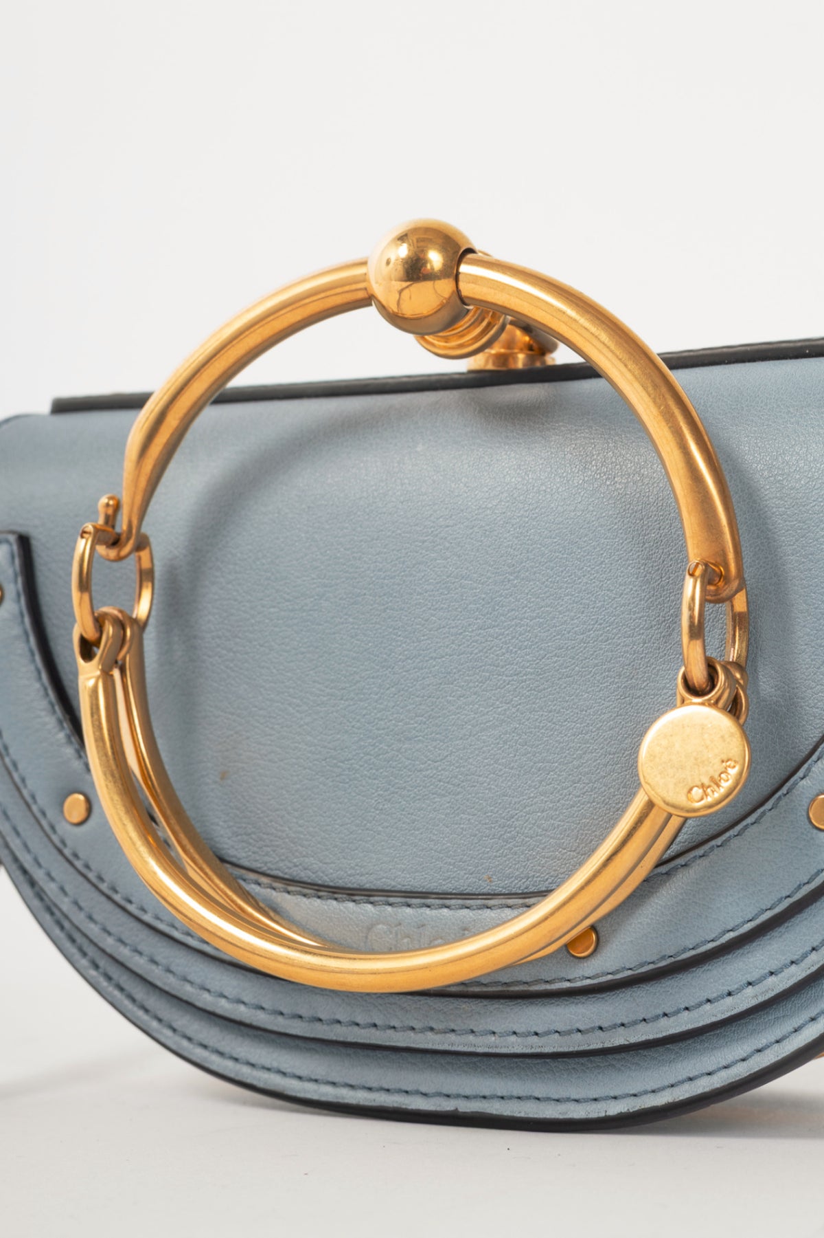 Chloe blue circle handle nile clutch